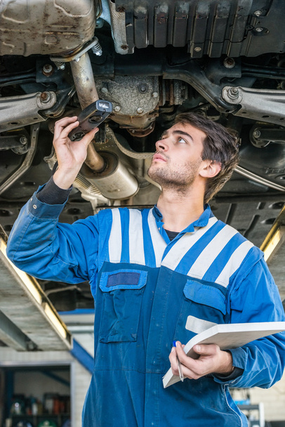 Male mechanic working under the car - Фото, зображення