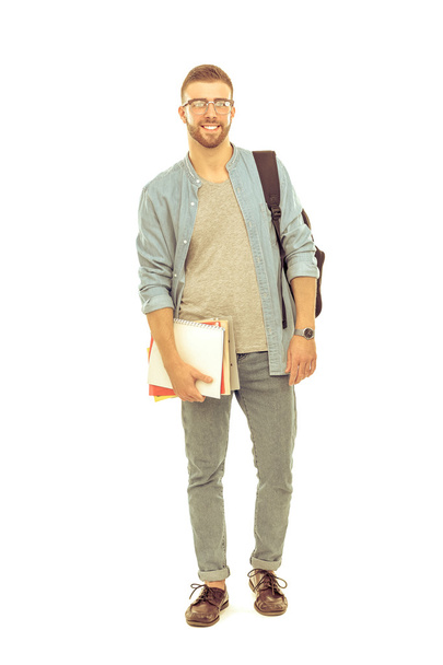 A male student with a school bag holding books isolated on white background - Foto, Imagem