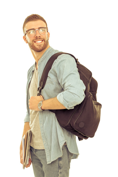 白い背景で隔離の書籍を保持している学校のバッグを持つ男性の学生 - 写真・画像