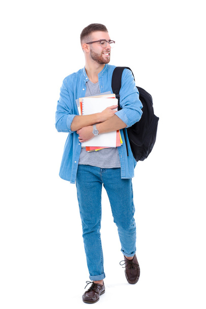 A male student with a school bag holding books isolated on white background - Valokuva, kuva