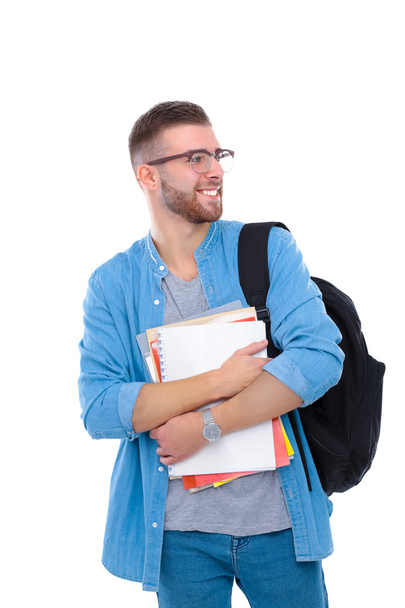 A male student with a school bag holding books isolated on white background - Фото, зображення