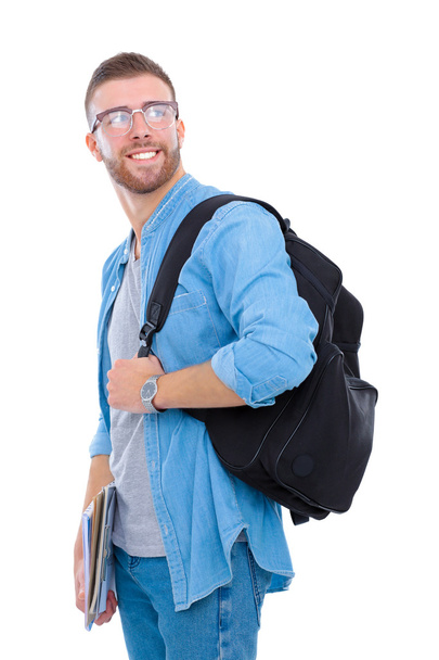 Un estudiante masculino con una bolsa de la escuela sosteniendo libros aislados sobre fondo blanco
 - Foto, imagen