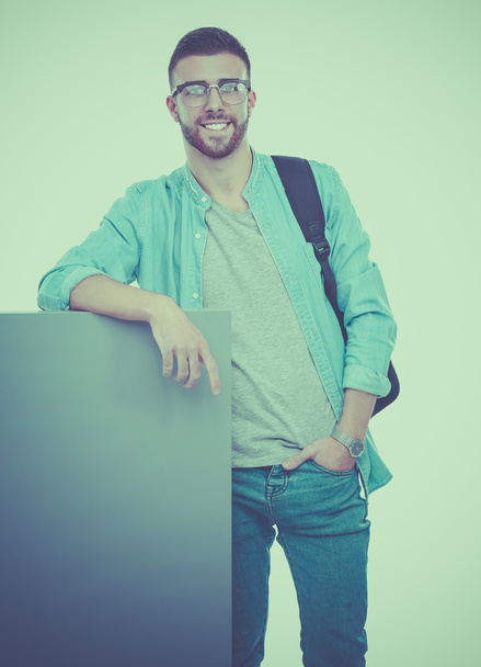 Portrait of a smiling male student holding blank board - Valokuva, kuva