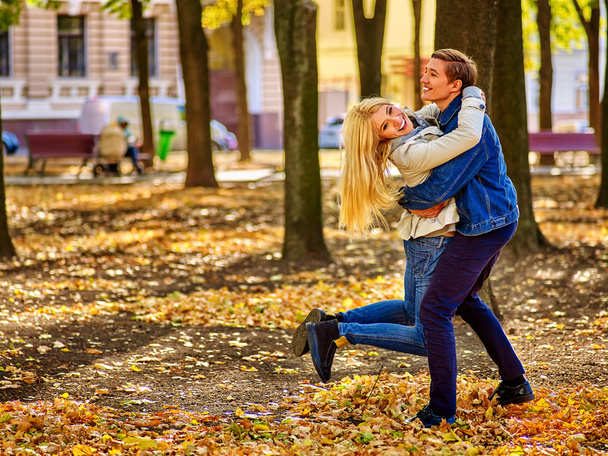 Young couple active rest in open air in autumn park. - Foto, Bild