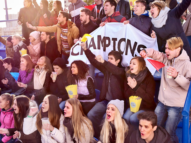 Sport fans holding champion banner on tribunes. - Photo, Image