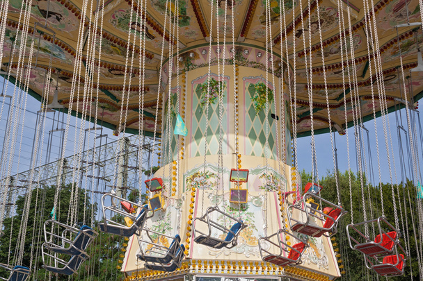 chairoplanes against a blue sky in an amusement park - Photo, Image