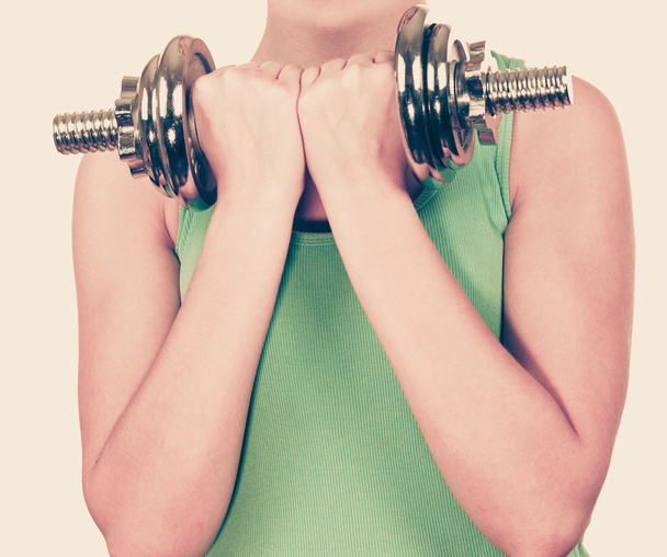 Woman exercising with dumbbells lifting weights  - Foto, imagen