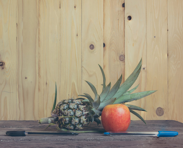 Pen-ananas-Apple-Pen op houten achtergrond. - Foto, afbeelding