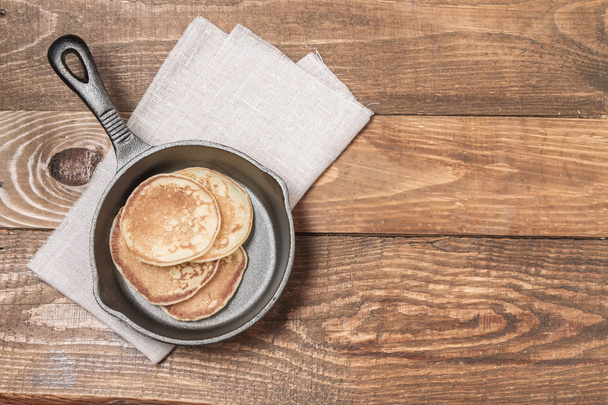 Pancakes and frying pan - Фото, изображение