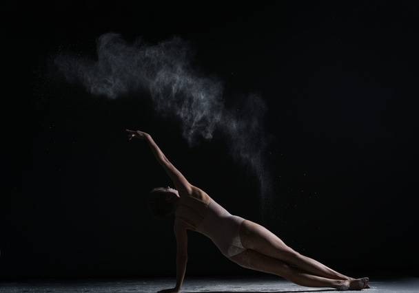 Modern art. Girl dancing with cloud of dust - Fotoğraf, Görsel