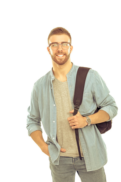 Young man standing with handbag, - Φωτογραφία, εικόνα