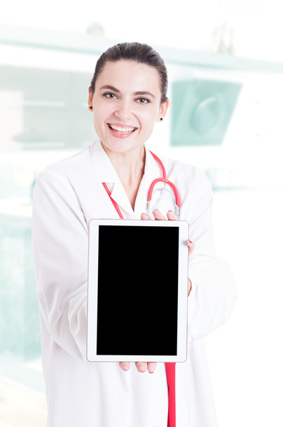 Trustworthy medical specialist holding modern tablet - Фото, изображение