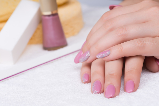 Fingernails with pink polish and glitter  - Photo, Image