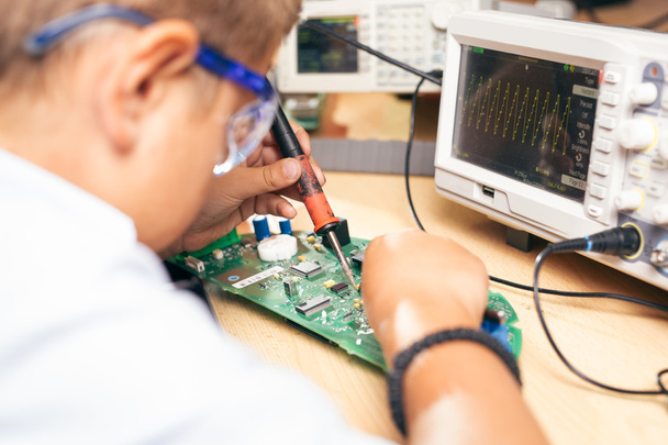 Young boy working on an electronics project - Фото, зображення