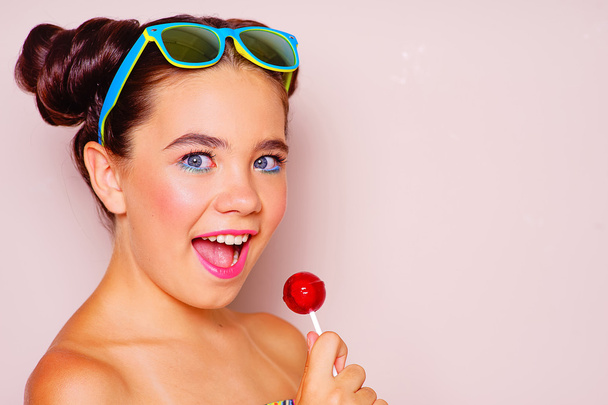Young girl with sunglasses and lollipop - Foto, Imagem