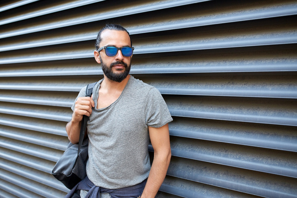 man with backpack standing at city street wall - Valokuva, kuva