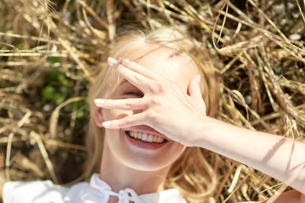 happy young woman lying on cereal field - Фото, зображення