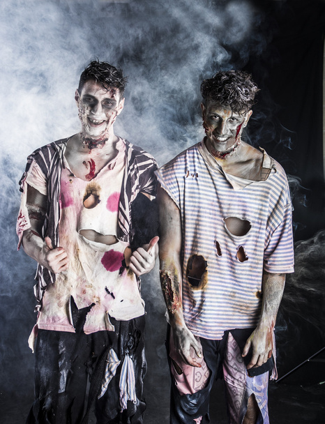 Two male zombies standing on black smoky background - Photo, image