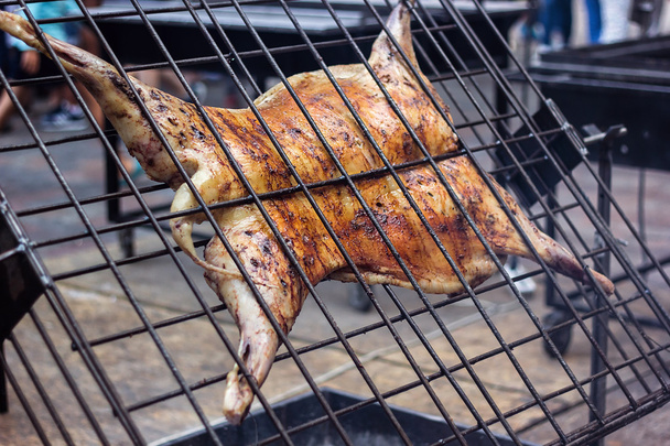 Appetizing grilled lamb on the spit. Roasted pig on traditional barbecue. Roasting barbecue is prepared of a ram pig baked pork meat Street food Whole carcass pig roasting on the grill over charcoal. - Photo, Image