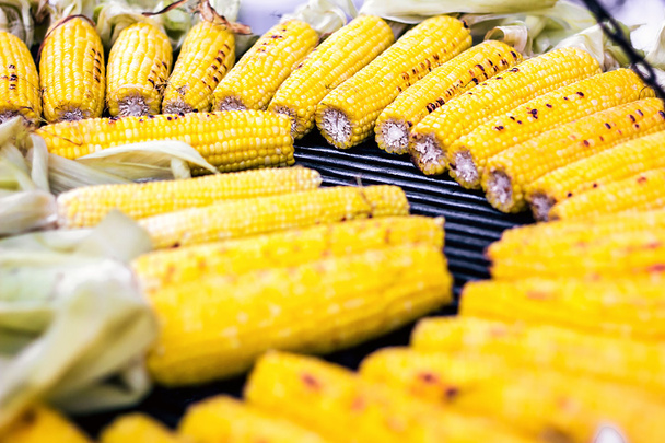 Closeup delicious BBQ grilled Mexican corn on the cob, vegetable food background. Barbecued roasted on the hot stove fresh tasty sweet corn. Ready to Eat. - Photo, Image