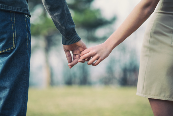 young couple holding hands together - Foto, imagen