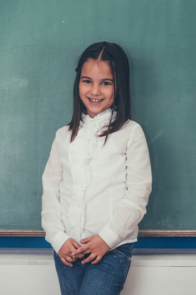 schoolgirl standing near chalkboard - Photo, Image