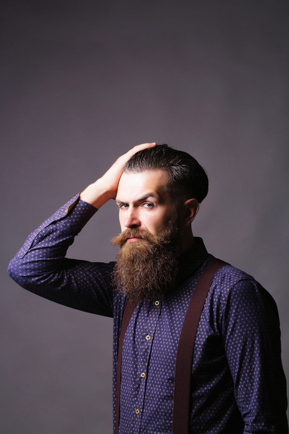 Man hipster tidies hair - Fotó, kép