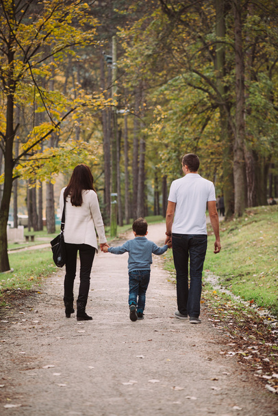 family walking in autumn park - 写真・画像