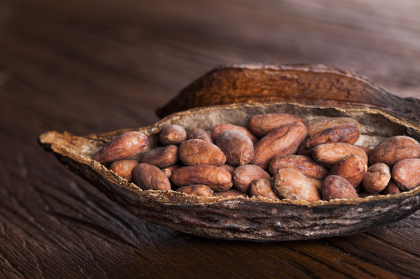 Cocoa pod on wooden background - Photo, Image