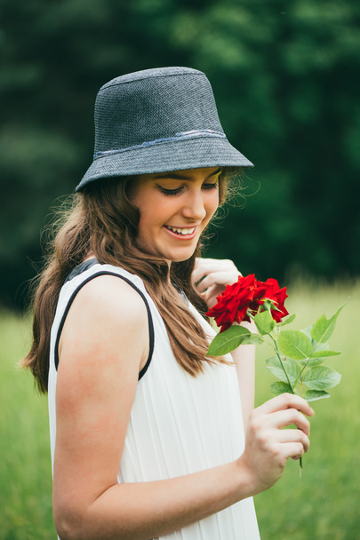 teenage girl holding branch of red roses - Foto, immagini