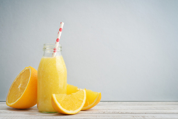 Orange smoothie in retro bottle - 写真・画像