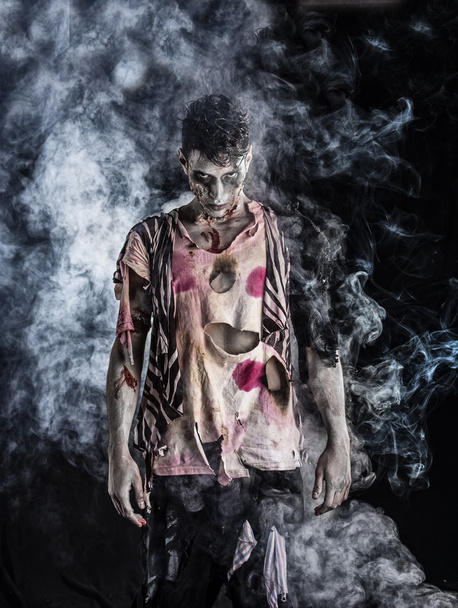 Male zombie standing on black blackground - Foto, Imagen