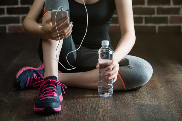 take rest listening to music drinking water after fitness exerci - Fotó, kép