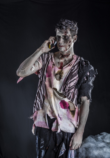 Male zombie using cell phone to make a call, standing - Photo, image