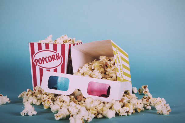 Popcorn bucket against a blue background Vintage Retro Filter. - Photo, Image