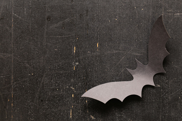 paper origami bats on a wooden background, decorations for the holiday Halloween - Фото, зображення
