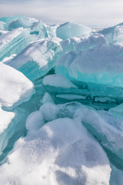Ice chunks of blue ice is covered with snow - Foto, Imagen