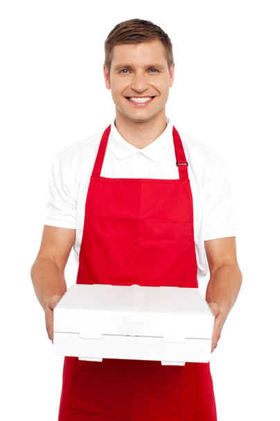 A chef in red uniform offering you a pizza box - 写真・画像