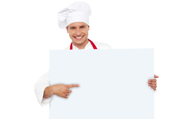 Chef pointing at the blank white billboard - Фото, зображення
