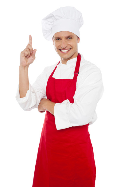 Happy smiling chef showing index finger - Foto, afbeelding