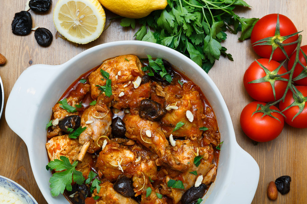 meal of chicken tagine stew in a spicy, nutty tomato sauce and prunes - Photo, Image
