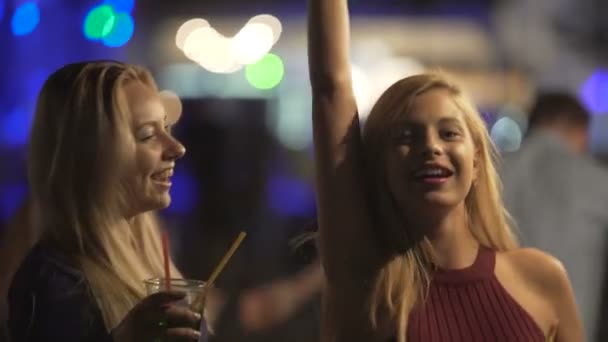 Attractive flirty blondes moving sexy bodies to music and having fun at party - Footage, Video