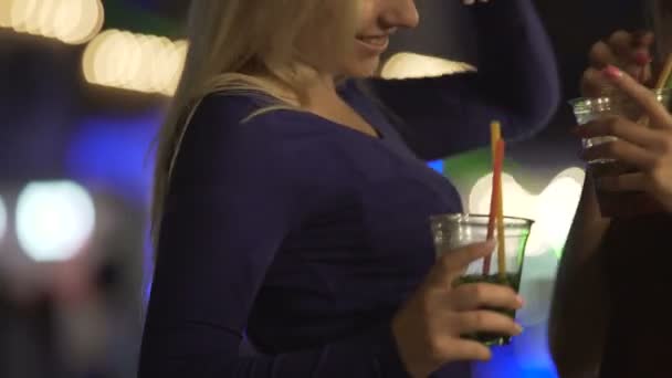 Sexy blonde beauties drinking cocktails, dancing to music, flirting at party - Footage, Video