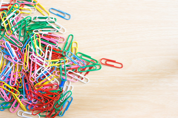 many multicolored paper clips on white table - Photo, image