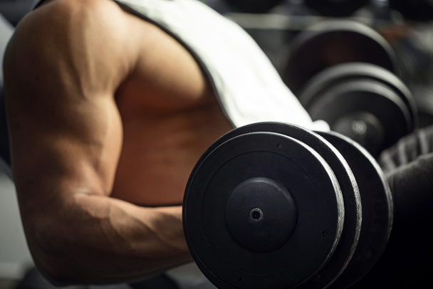 Close up of a dumbbell in hands - Foto, afbeelding