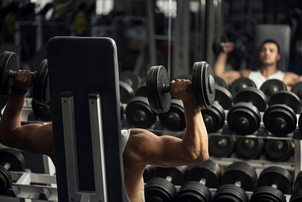 Strong hard working man lifting weight - 写真・画像