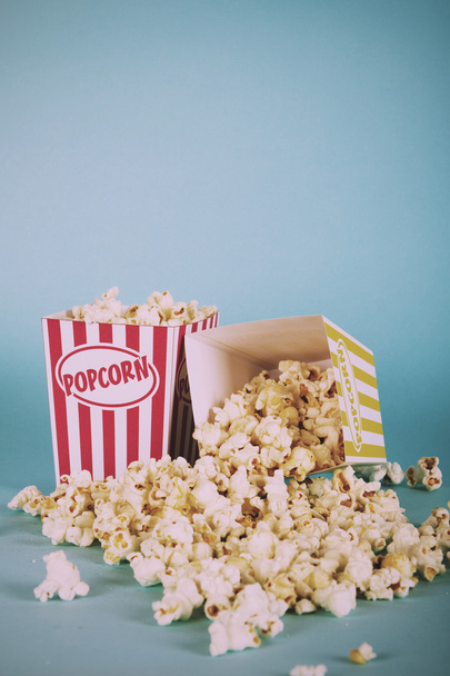 Popcorn bucket against a blue background Vintage Retro Filter. - Fotó, kép