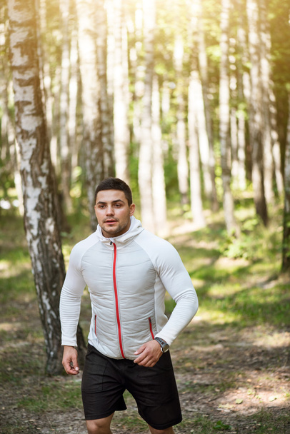 Serious confident man running in the trees - Foto, immagini