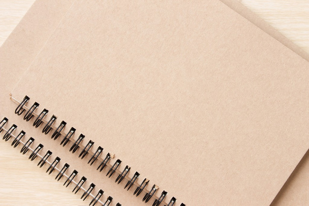 empty notebook with a pencil on the brown wooden background - Fotoğraf, Görsel