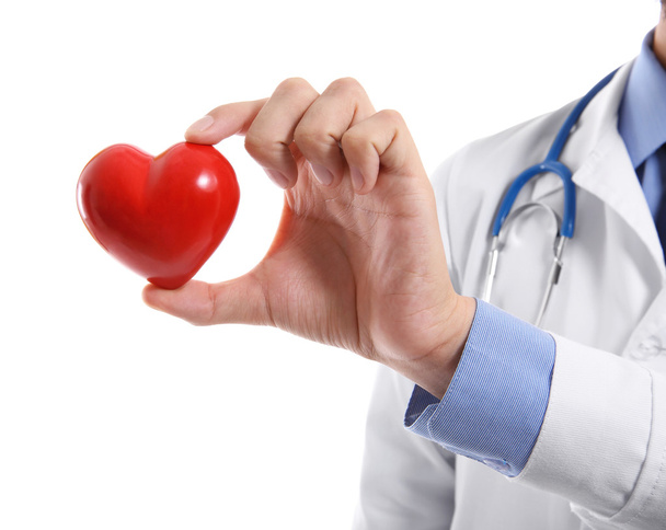 Male doctor holding red heart on white background - Фото, изображение